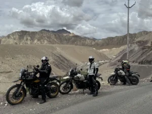 Riders on a desert mountain road on a D'Himalayan Riders tour