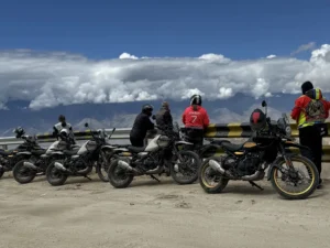 Royal Enfield motorcycles lined up at a high Himalayan viewpoint