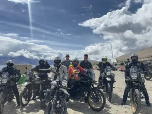 D'Himalayan Riders group with their motorcycles under a big Ladakh sky