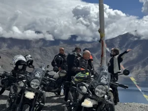 Riders on Royal Enfield Himalayan motorcycles at a Ladakh mountain stop